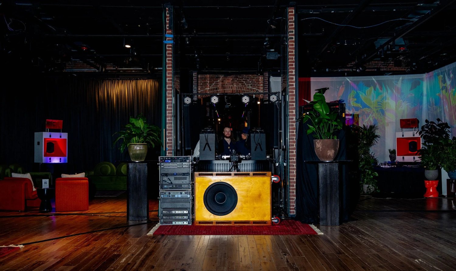 Sound Logic orange horn speakers and wood-finished subwoofer at a Boston Art Review event